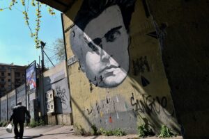 A man walks past a mural of Italian writer Antonio Gramsci in Rome on March 31, 2014. © Alberto Pizzoli/AFP/Getty