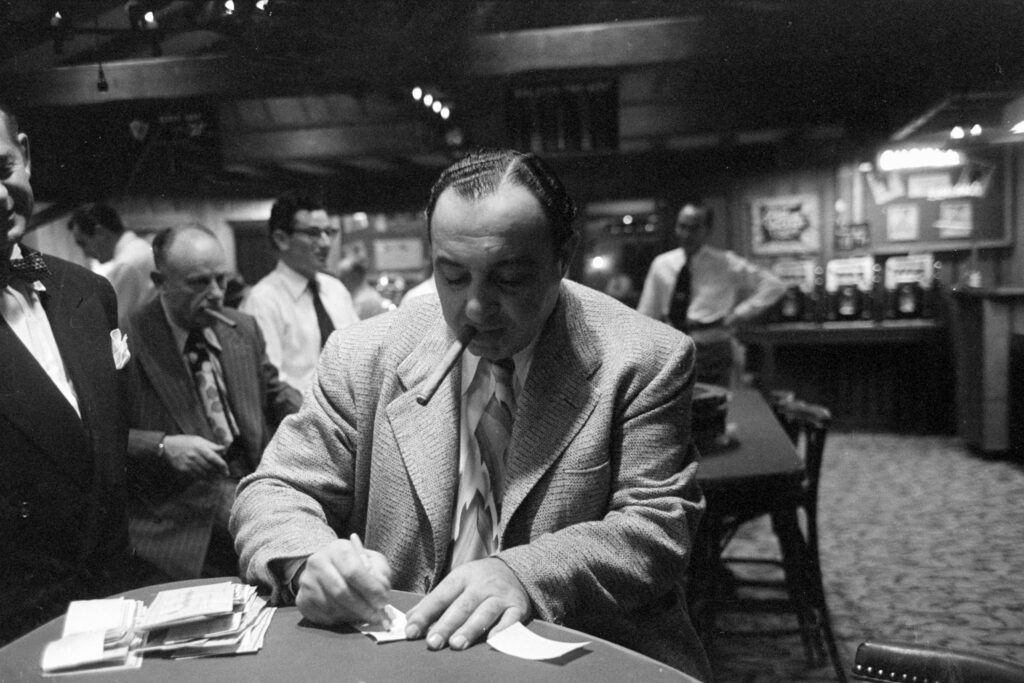 Mafia boss Mickey Cohen signing documents in Los Angeles circa 1950. © Peter Stackpole/LIFE/Shutterstock