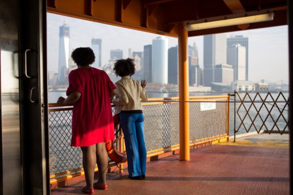 Passengers look towards the financial district from a ferry in New York City. © Julian Röder/Ostkreuz/Redux