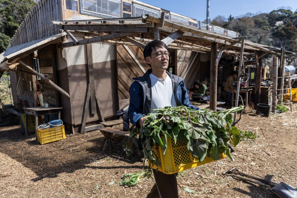 Philosopher and author Kohei Saito working on a collective farm in Kanagawa, Japan, on March 16, 2023. © Shiho Fukada/NYTimes/Redux