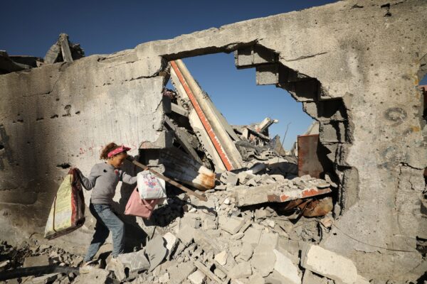 A Palestinian child collects wood, paper and cardboard from the rubble of buildings to use as fuel in Gaza City, Gaza, on March 05, 2024. © Dawoud Abo Alkas/Anadolu/Getty