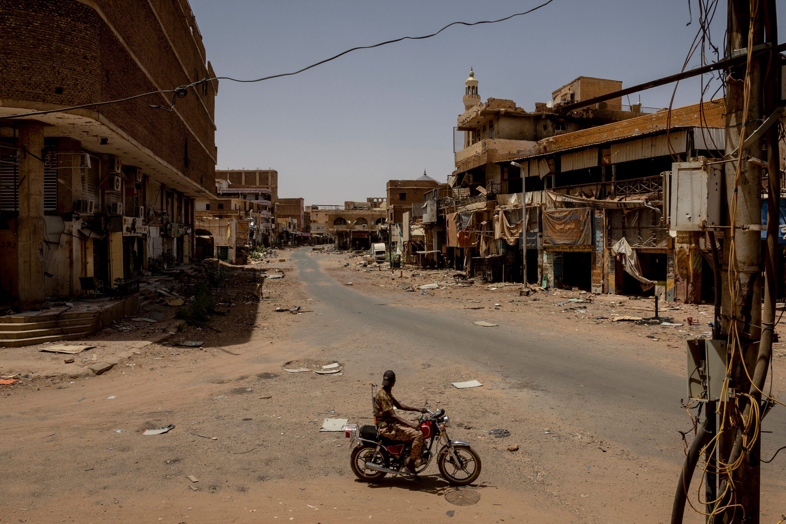 A Sudanese Armed Forces soldier rides through the ruins of a historic market in Omdurman, Sudan, on April 22, 2024. © Ivor Prickett/NYTimes/Redux