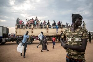 People fleeing the Sudanese war disembark from a truck which has brought them to Renk from the Joda border crossing in South Sudan, on March 25, 2024. © Sally Hayden/Sopa/Sipa/AP