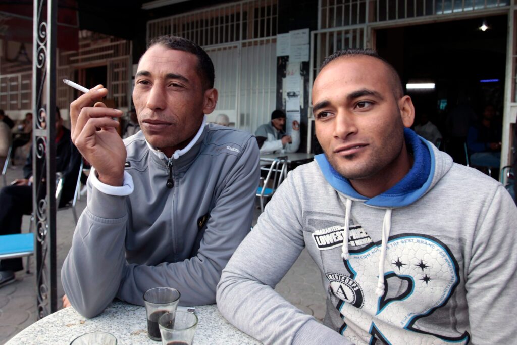 Two men discuss joblessness and the upcoming elections at a cafe in Kasserine, Tunisia, on October 23, 2014. © Zoubeir Souissi/Reuters/Redux