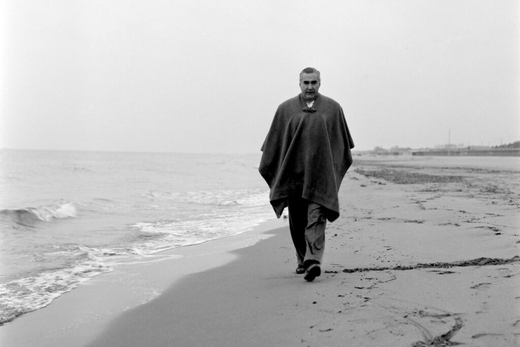 Curzio Malaparte strolls on the beach near his home in Forte dei Marmi, Italy, in 1954. © Graziano Arici/eyevine/Redux