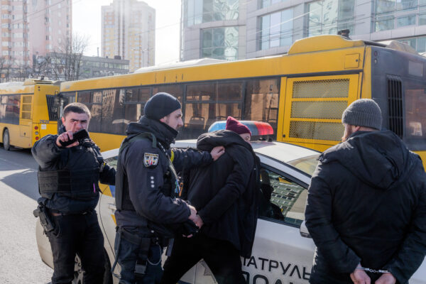 Members of the National Police detain two civilians in Kyiv in 2022. © Emanuele Satolli/Contrasto/Redux